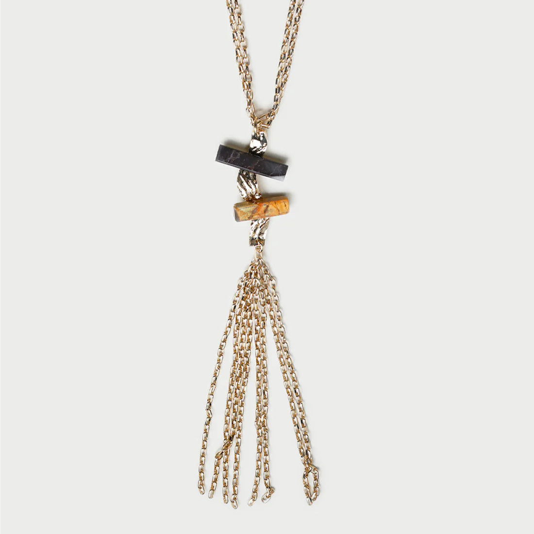 Necklace with tassel pendant on a light gray background