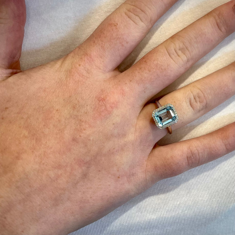 Emerald Cut Blue Topaz & Diamond Halo Ring in 9ct White Gold