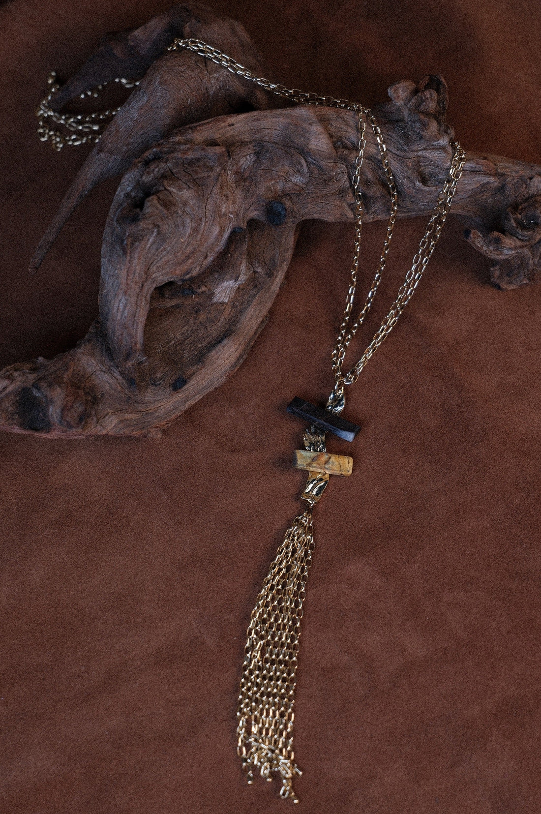 Long gold necklace with stones and tassle detail