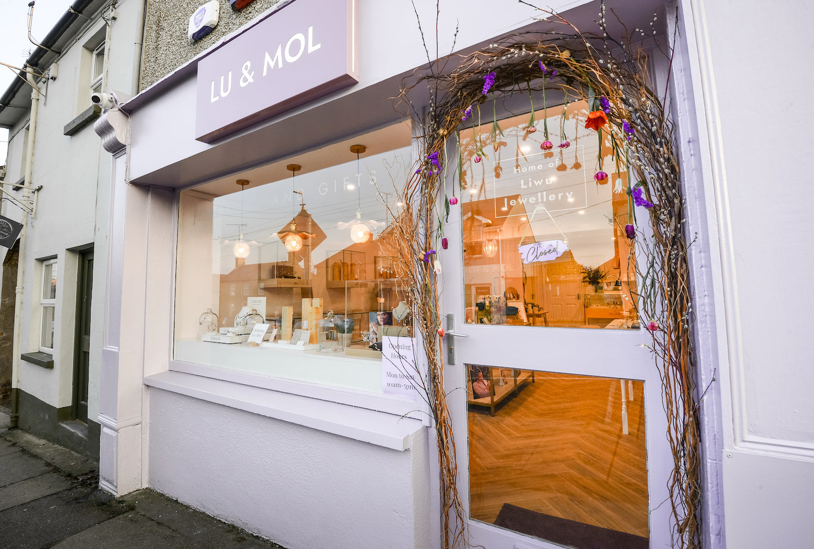 the front of a purple and white jewellery store with sign "Lu & Mol" and a willow arch over the doorway