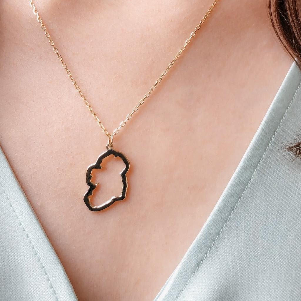 a Gold Plated over sterling Silver Map of Ireland Necklace on a girls neck