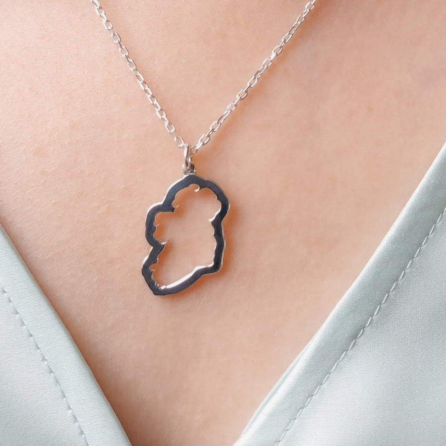 a sterling Silver map of Ireland Necklace on a women's neck 