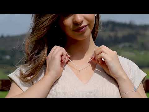 dara knot sterling silver necklace on a model with a field in the background