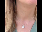 a video featuring sterling silver dara knot drop earrings on a woman's ear